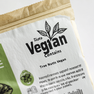 Close-up of a vegan product’s Nutrition Facts panel, highlighting the allergen statement ‘Contains: Soy, Tree Nuts.